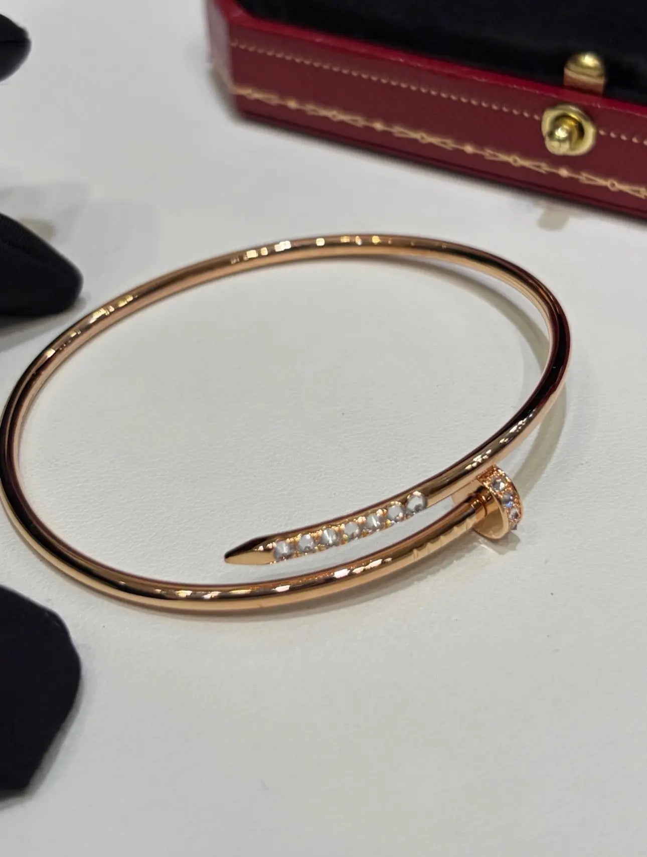 Cartier gold bracelet jewelry with sleek design and polished finish, displayed on a neutral background.