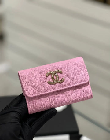 LuxeLash Studio pink mini wallet from Chanel, compact leather wallet with gold-tone logo and card slots.