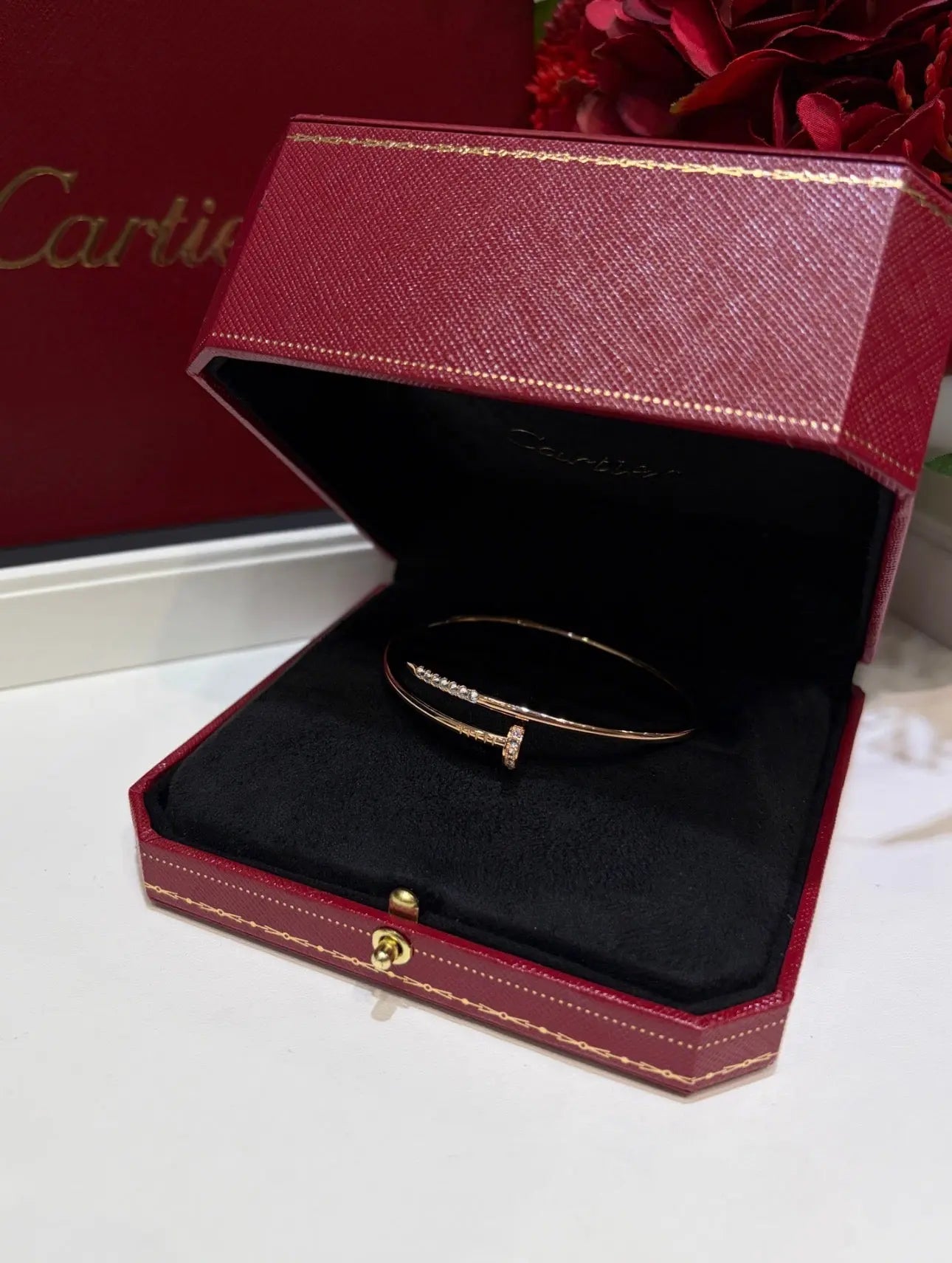 Gold Cartier bracelet with sleek jewelry design, showcasing smooth links and a polished finish.